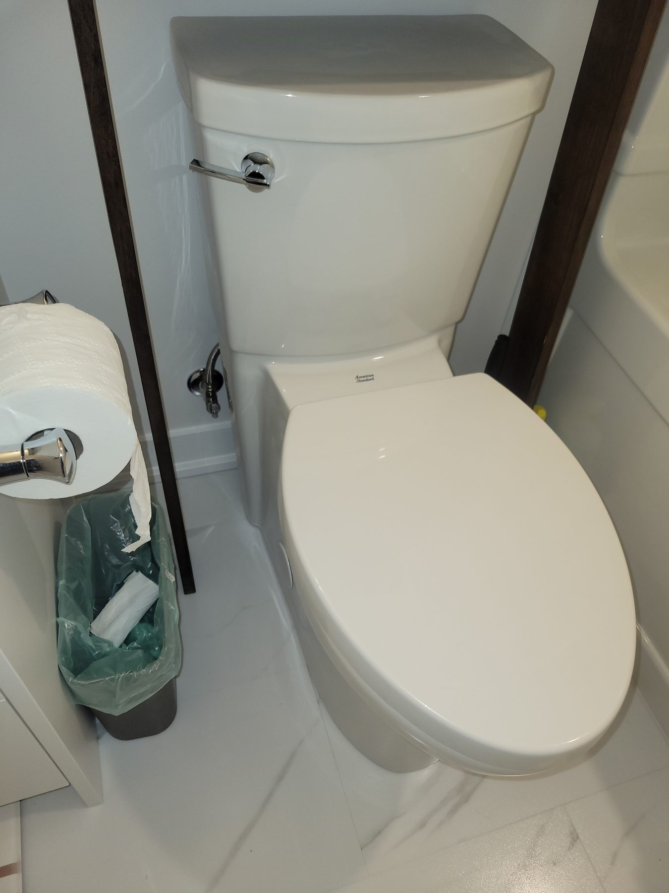 Finished toilet install in a compact bathroom