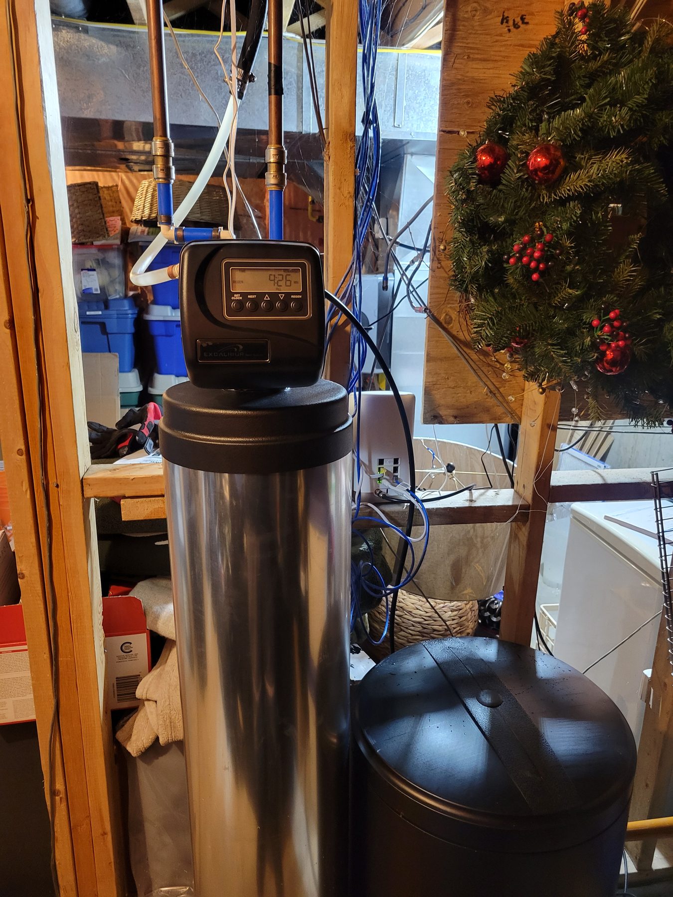 Stainless water softener and brine tank installed in a home basement