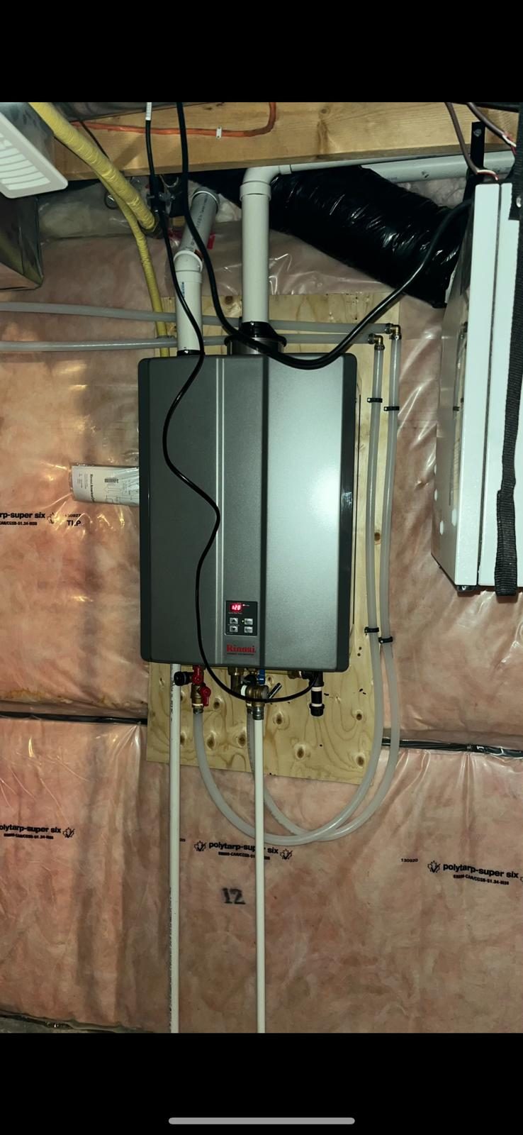 Wall-mounted tankless water heater installed on bare studs