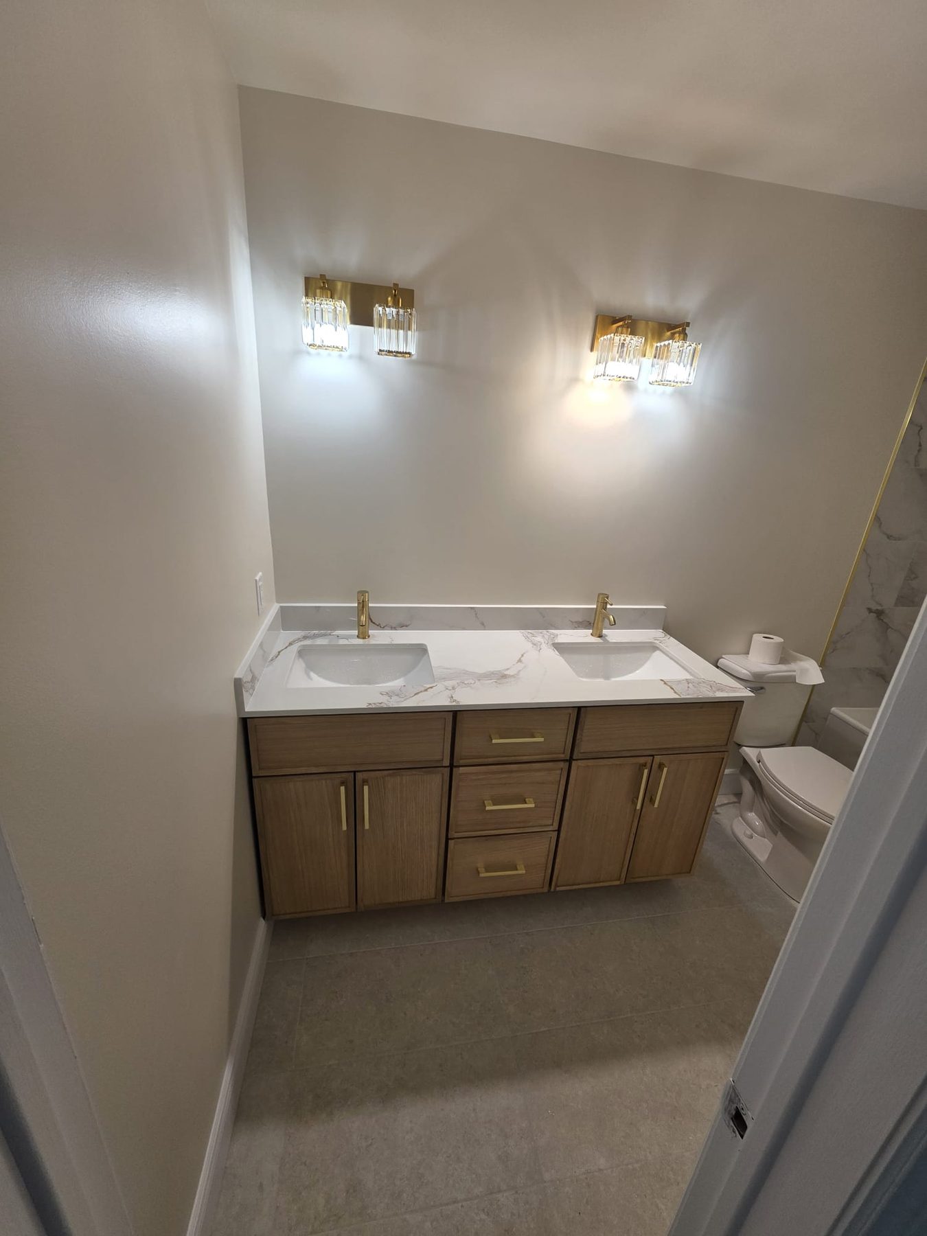 Finished bathroom with a double vanity and new faucets