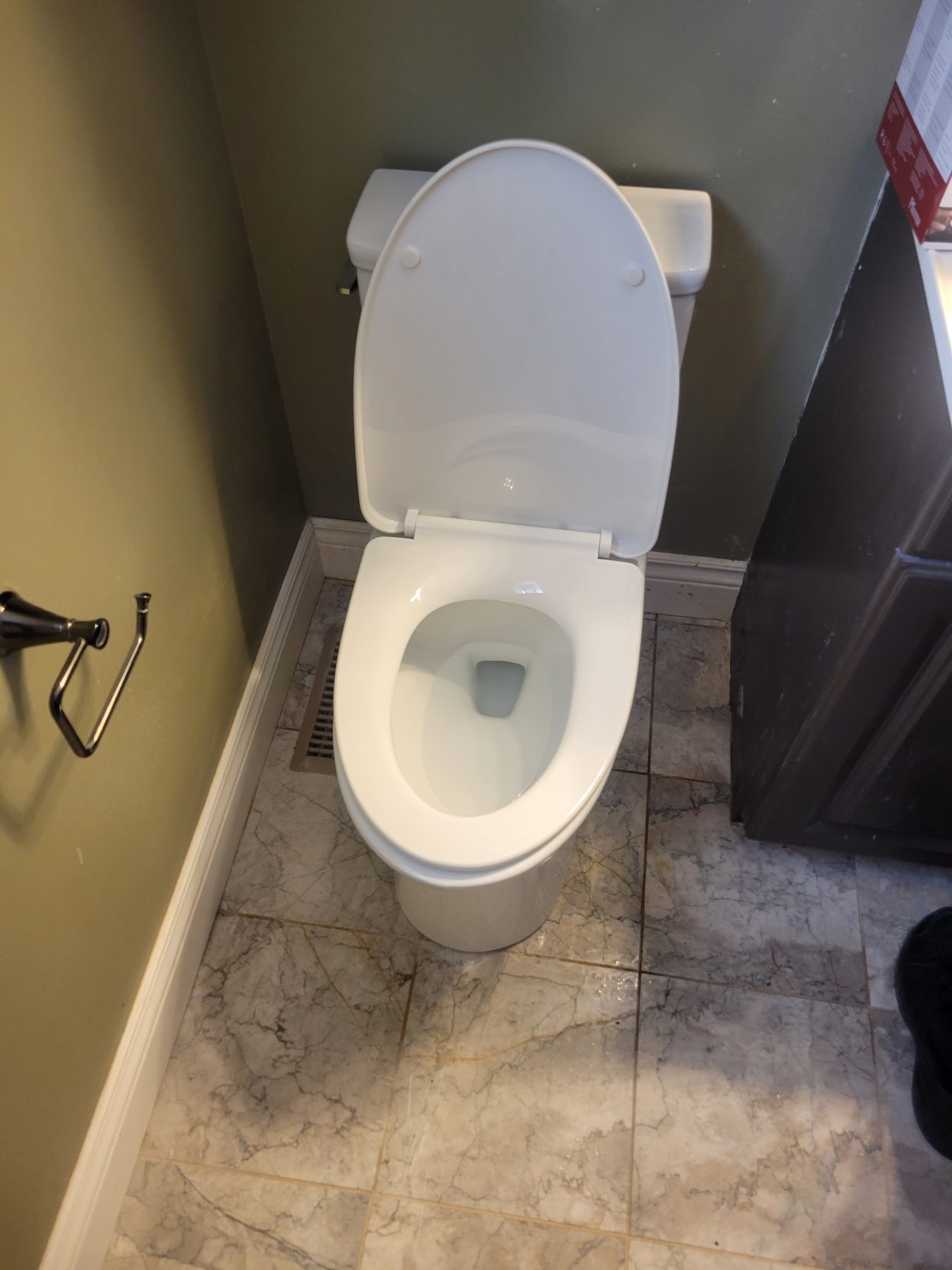 New toilet installed on marble tile